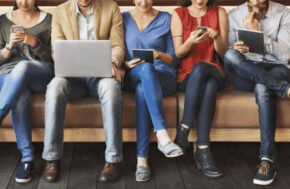 hommes et femmes sur un banc avec leurs ordinateurs qui consultent des sites de rencontres