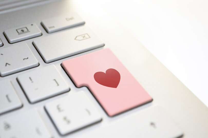 Photos d ’un clavier d’ordinateur portable qui montre un cœur sur le touche entre, en référence avec la facilité de rechercher des relations extraconjugales sur internet.